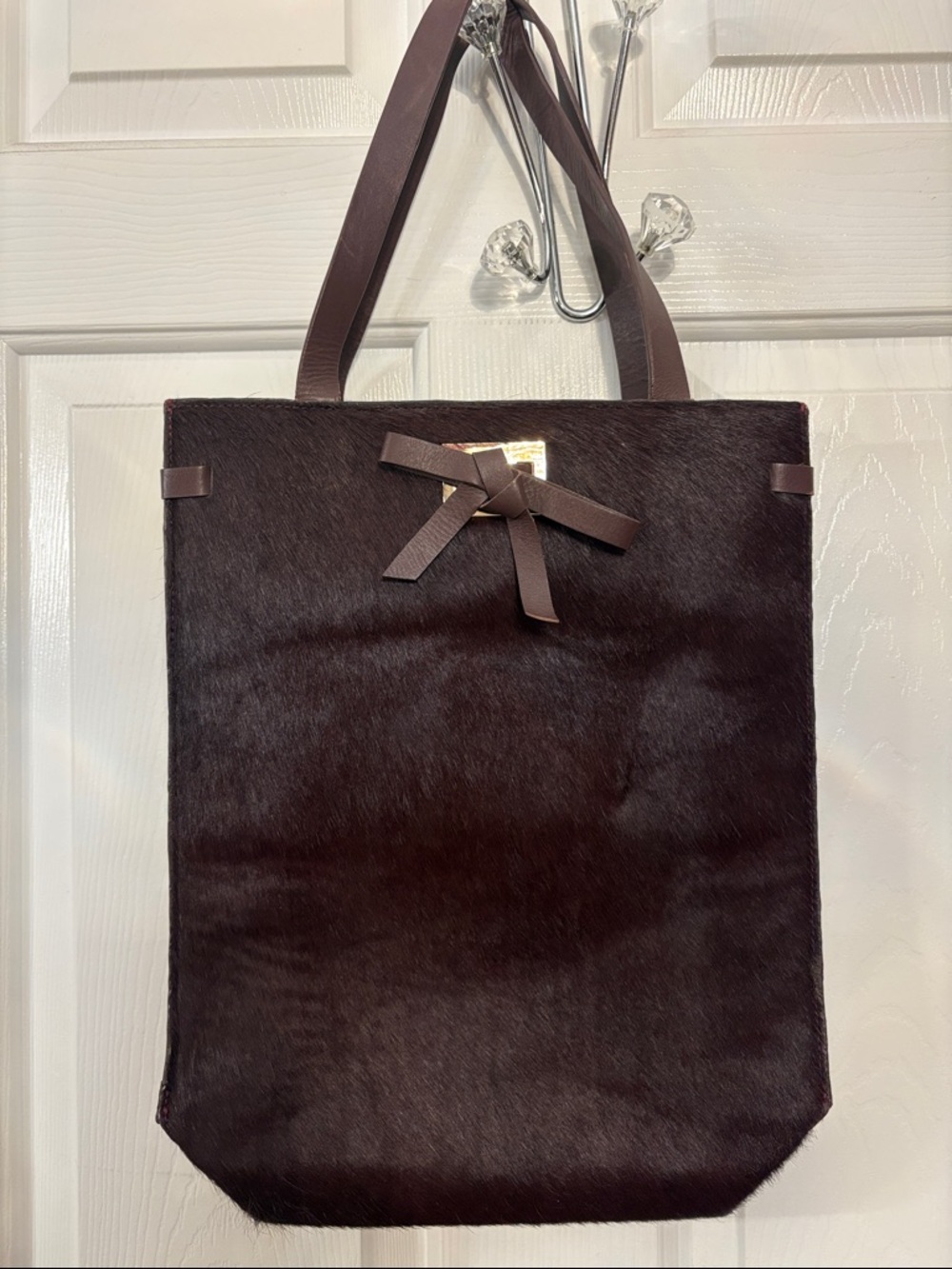 BODEN CALF HAIR- deep plum tote bag made of cowhide leather with a bow detail.